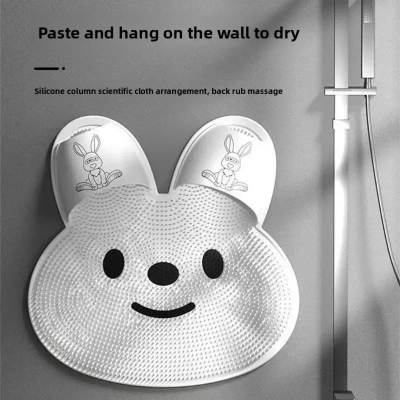 The bunny mat stuck to a shower wall beside the shower head